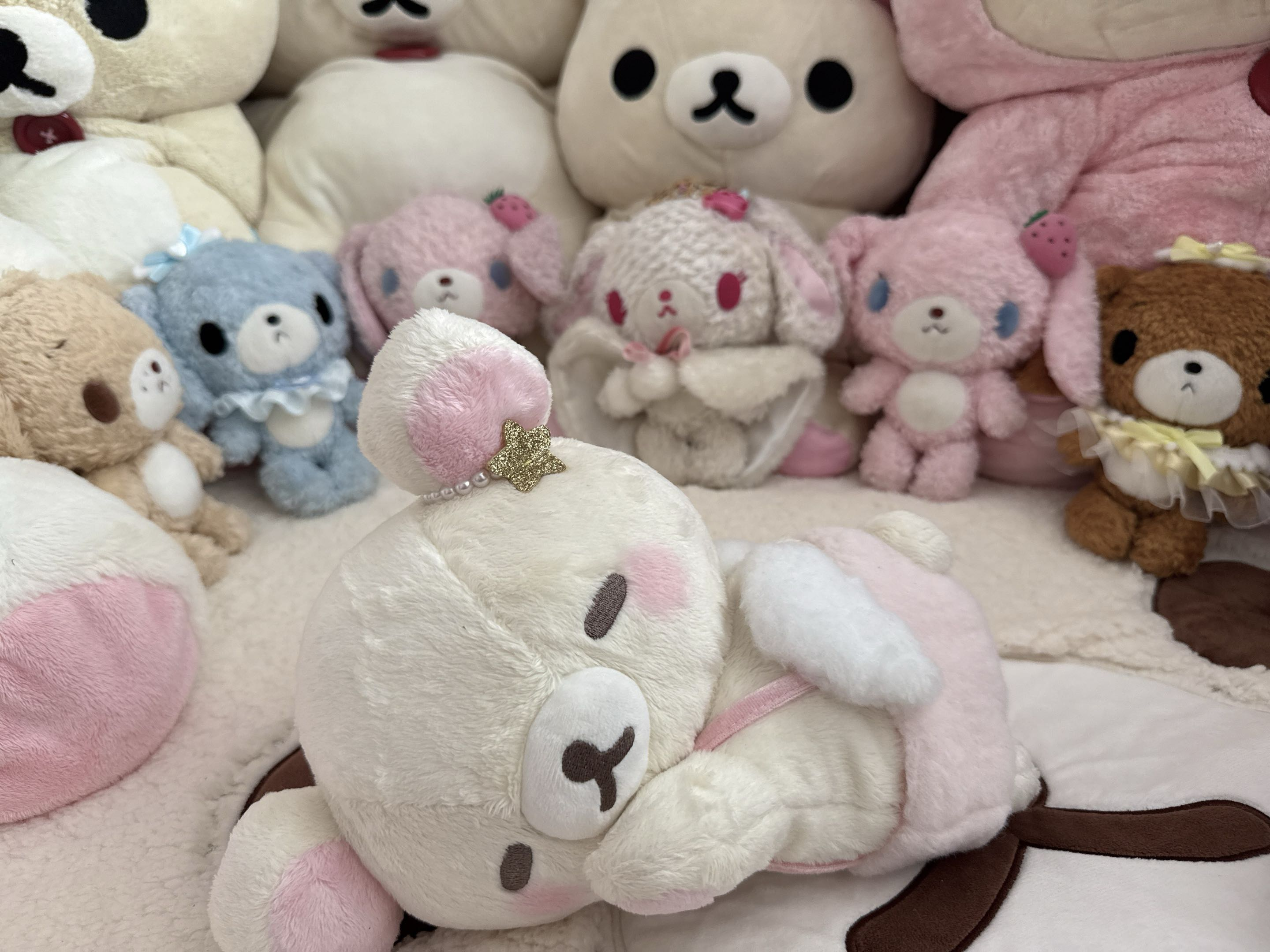 A shelf of Korilakkuma plushies